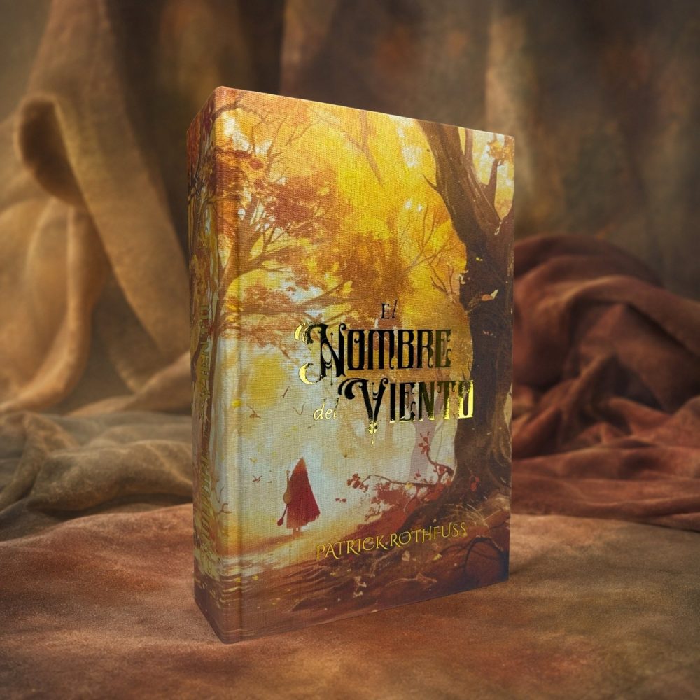 Cubierta de El Nombre del Viento edición especial, con el bosque otoñal y la figura de capa roja